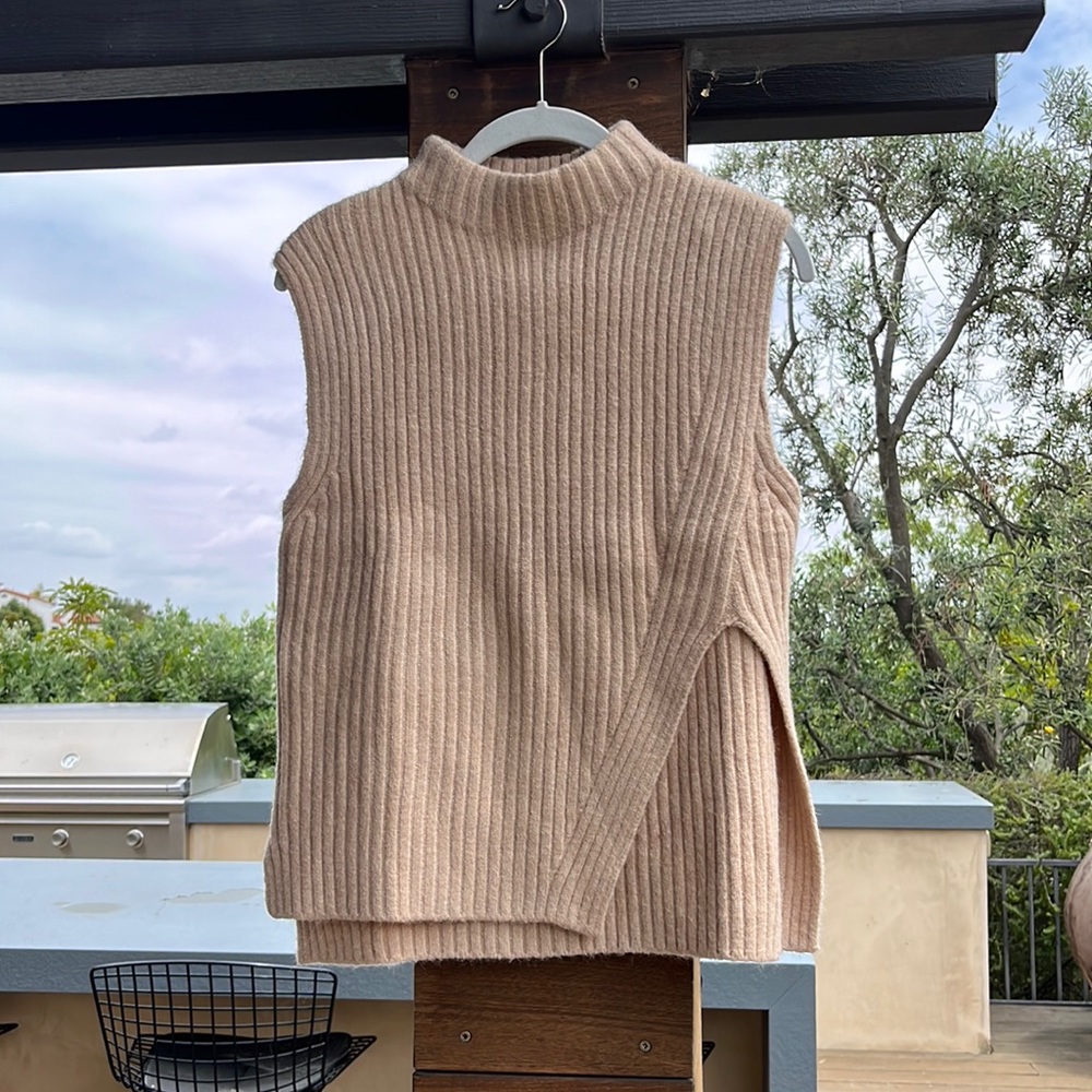 Tan-colored sweater vest with short turtleneck and design cut out